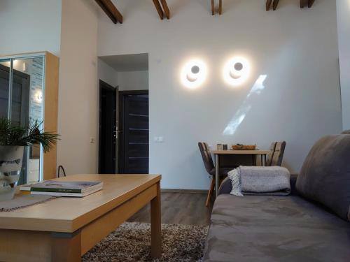 a living room with a couch and a table with eyes on the wall at PUŠIES namai in Nida