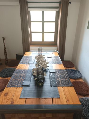 a dining room table with a centerpiece on top of it at Burgapartment Felsenhäuschen in Monschau