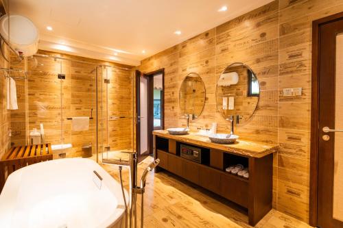 a bathroom with wooden walls and a toilet and a sink at H Resort - The Coral Cliff in Calape