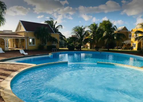a large pool with blue water in front of a house at Le Rock @ Albion in Albion