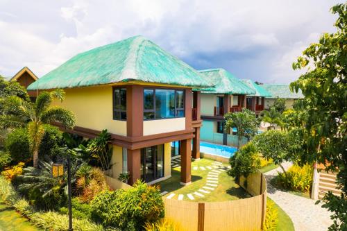 a house with a green roof at H Resort Bohol - The Coral Cliff by SMS Hospitality in Calape