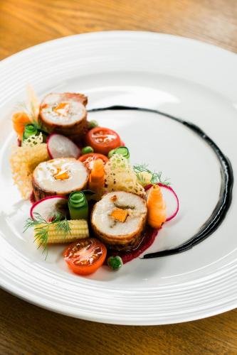 a plate of food with vegetables on a table at H Resort Bohol - The Coral Cliff by SMS Hospitality in Calape