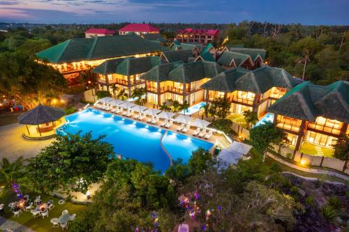 an aerial view of a resort with a swimming pool at H Resort Bohol - The Coral Cliff by SMS Hospitality in Calape