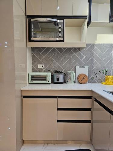 a kitchen with a microwave and a toaster oven at Casa Nayah Cebu City Transient Entire Home in Cebu City