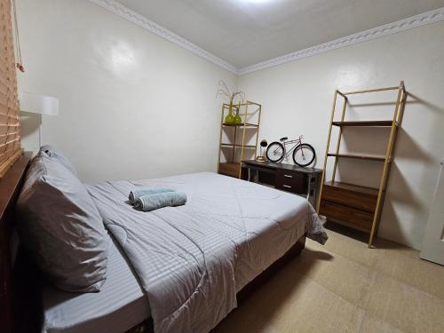 a bedroom with a bed and a book shelf at Casa Nayah Cebu City Transient Entire Home in Cebu City