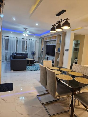 a living room with a table and chairs at Casa Nayah Cebu City Transient Entire Home in Cebu City