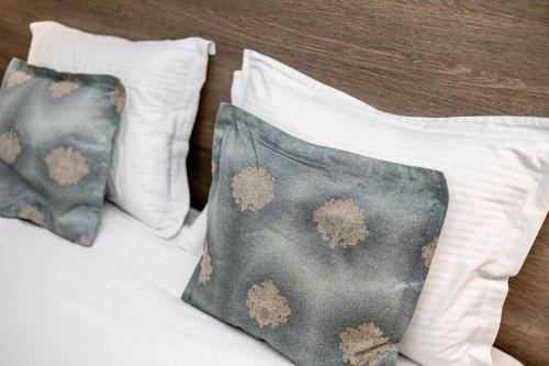 two pillows sitting on top of a bed at ForS Konak Apartments in Belgrade