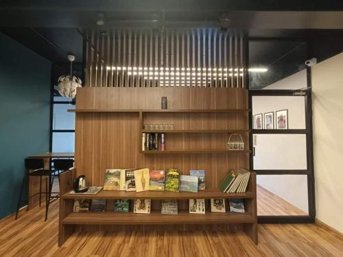 a room with a book shelf with books on it at TRIVPODS Capsule Hotel in Trivandrum