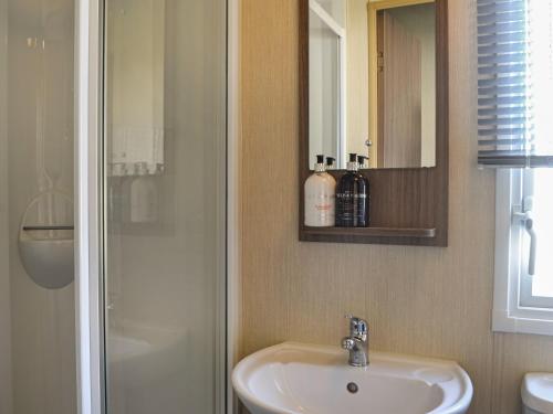 a bathroom with a sink and a shower at Lakeland View 69 - Uk44196 in Mainsriddle