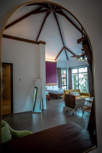 a living room with a couch and a mirror at Tana Mysterious garden in Panglao