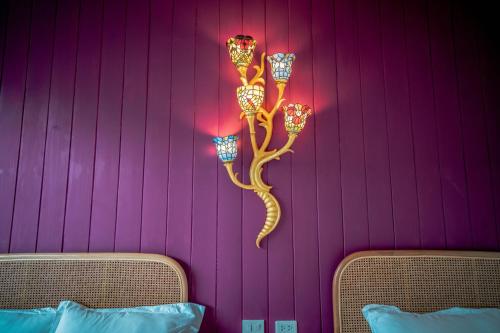 a wall with a lizard shaped wall light on it at Tana Mysterious garden in Panglao