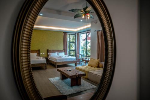 a mirror reflecting a living room with a couch and a table at Tana Mysterious garden in Panglao Island