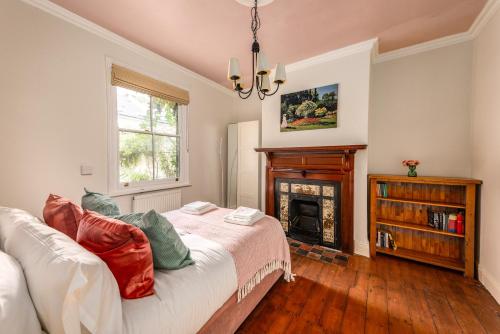 - un salon avec un lit et une cheminée dans l'établissement 5 bed Central Cambridge House, à Cambridge