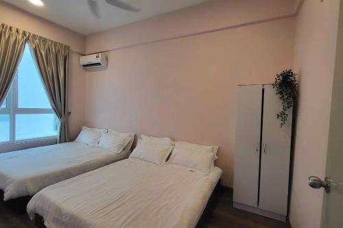 a bedroom with two beds and a window at Stay@12 D'Festivo Residence Ipoh Perak in Ipoh
