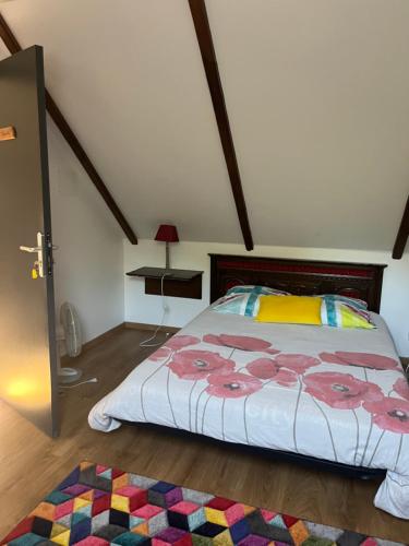 a bedroom with a large bed and a rug at Ar-Gavotenn in Le Saint