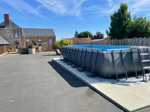 a large swimming pool in a parking lot at Le gîte de Kelly in Trémont