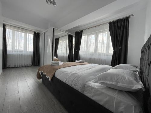 a bedroom with a large bed with a large mirror at Traveler’s Home in Suceava