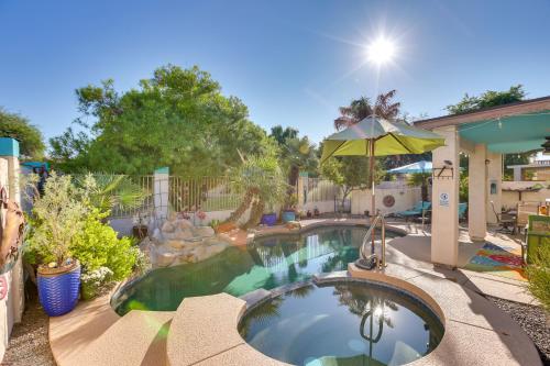 a swimming pool with an umbrella in a yard at 5 Mi to State Farm Stadium Home with Private Pool! in Avondale
