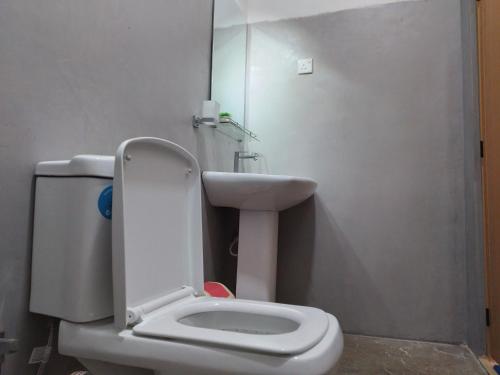 a bathroom with a toilet and a sink at Nirwana Resort in Habarana