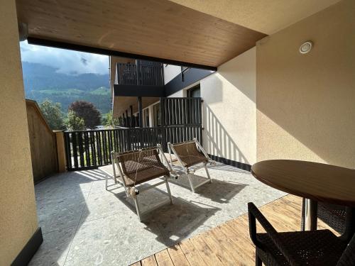 two chairs and a table on a balcony with a view at Residence Sägemühle in Prato allo Stelvio