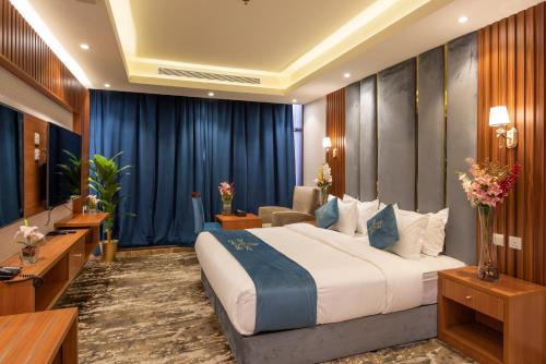 a hotel room with a bed and a television at Paradise Inn Jeddah Hotel in Jeddah