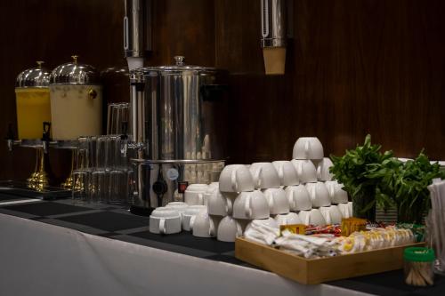 a counter with a mixer and a bunch of food at Paradise Inn Jeddah Hotel in Jeddah
