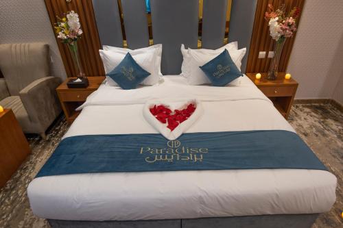 a hotel room with a bed with a heart on it at Paradise Inn Jeddah Hotel in Jeddah