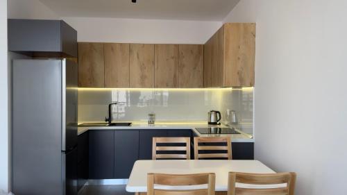 a kitchen with a white table and a sink at Urban Serenity Skyline View Apartment 2 in Tirana