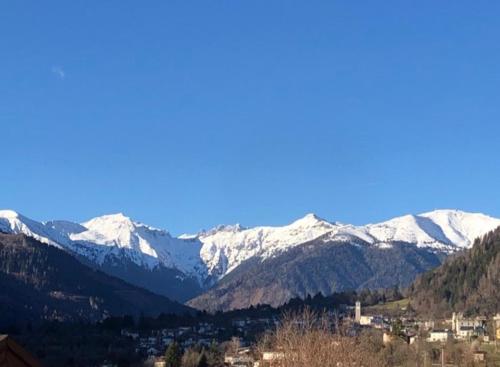 a mountain range with snow covered mountains in the distance at Holiday Guesthouse La Casina di Butzi pet friendly - Terme di Arta - Zoncolan in Arta Terme