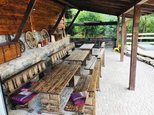 a group of wooden benches sitting inside of a building at Рандеву in Slavske