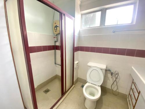 a bathroom with a toilet and a shower at BayView Suites Port Dickson By MAISON in Port Dickson
