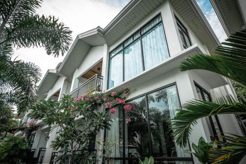 a house with large windows and plants at Tana Mysterious garden in Panglao