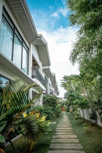 a walkway in front of a building with plants at Tana Mysterious garden in Panglao