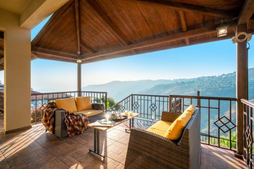 a balcony with a view of the mountains at Courtyard Villa by Hillstaytion,com in Panchgani