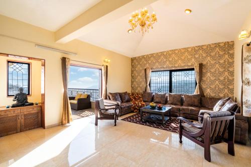 a living room with a couch and a table at Courtyard Villa by Hillstaytion,com in Panchgani
