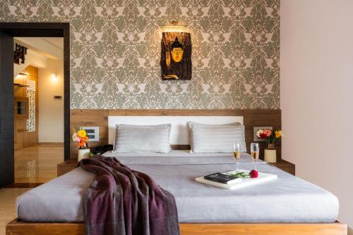 a bedroom with a large bed with a table at Courtyard Villa by Hillstaytion,com in Panchgani