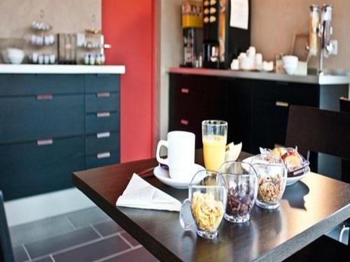 a table with bowls of food and drinks on it at Hôtel Cantal Cottages in Saint-Georges