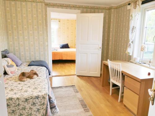 a bedroom with a bed with a teddy bear on it at Hus nära havet in Bergkvara