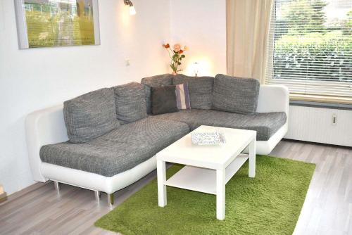 - un salon avec un canapé et une table dans l'établissement Carpe Diem Ferienwohnung Nr 97, à Niendorf