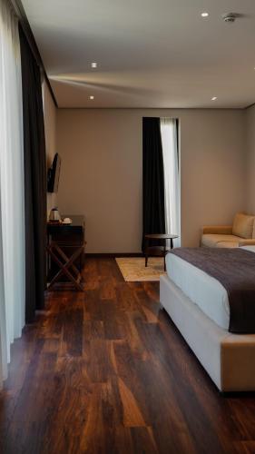 a bedroom with a bed and a desk in a room at Supreme Hotel in Golem