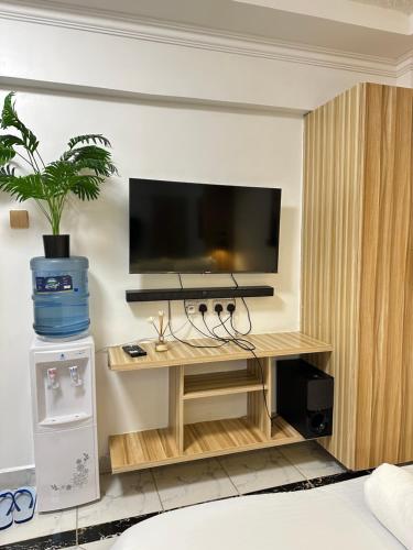 a room with a flat screen tv on a wall at Regency Homes II in Eldoret