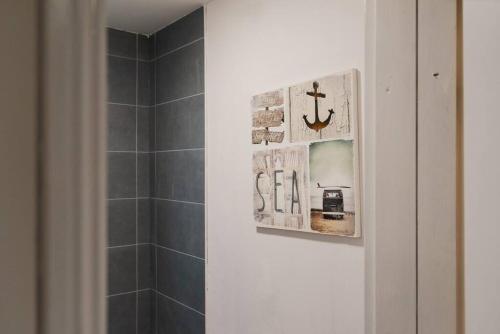 a bathroom with a shower with a tile wall at Brand New Must See Stylish Apt W/Free Parking in Leicester