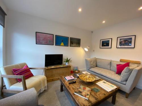 a living room with a couch and a coffee table at Stylish 3 bedroom apartment in historic city centre building in Sheffield
