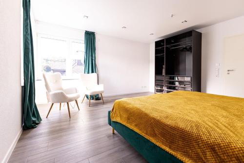 a bedroom with a bed and a table and chairs at Design Apartment zentral für 6 in Andernach: Ausblick, WiFi, Küche in Andernach