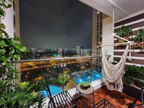 a balcony with a hammock and a view of the city at 30% promotion for Gold view apartment in the center of District 4, Ho Chi Minh, Vietnam in Ho Chi Minh City