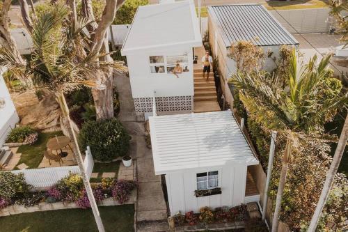 an overhead view of a white house with palm trees at George @ Ethel & Odes in Bundeena