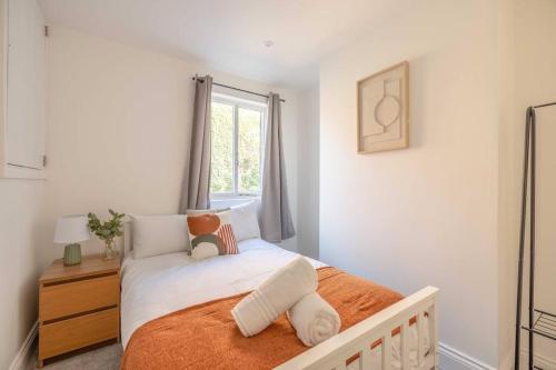 a small bedroom with a bed with a window at Cosy Cottage: Your Central Windsor Retreat in Windsor