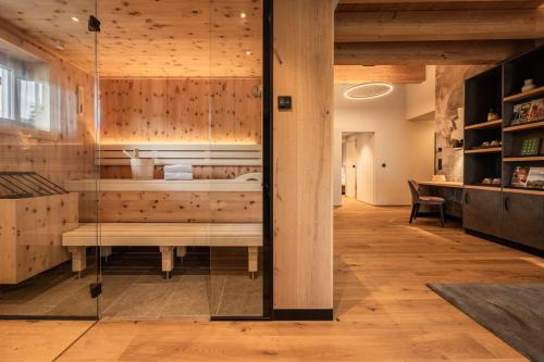 a room with a tub with a bench in it at Biohotel Leutascherhof in Leutasch