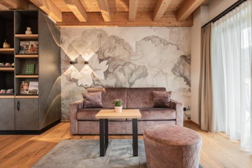 a living room with a couch and a table at Biohotel Leutascherhof in Leutasch