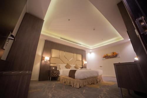 a bedroom with a large bed in a room at Guest House Hotel Apartments in Yanbu